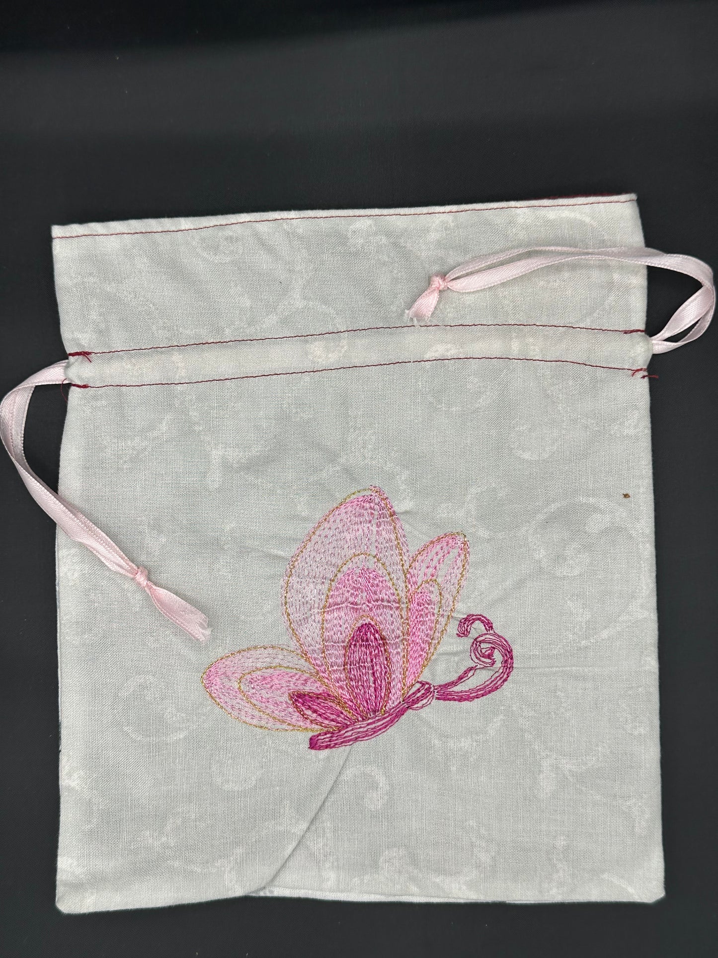 Embroidered butterfly draw string bag