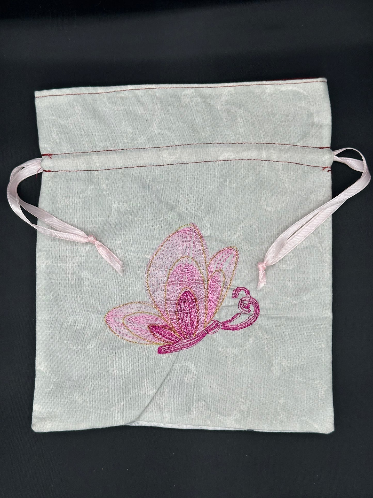 Embroidered butterfly draw string bag