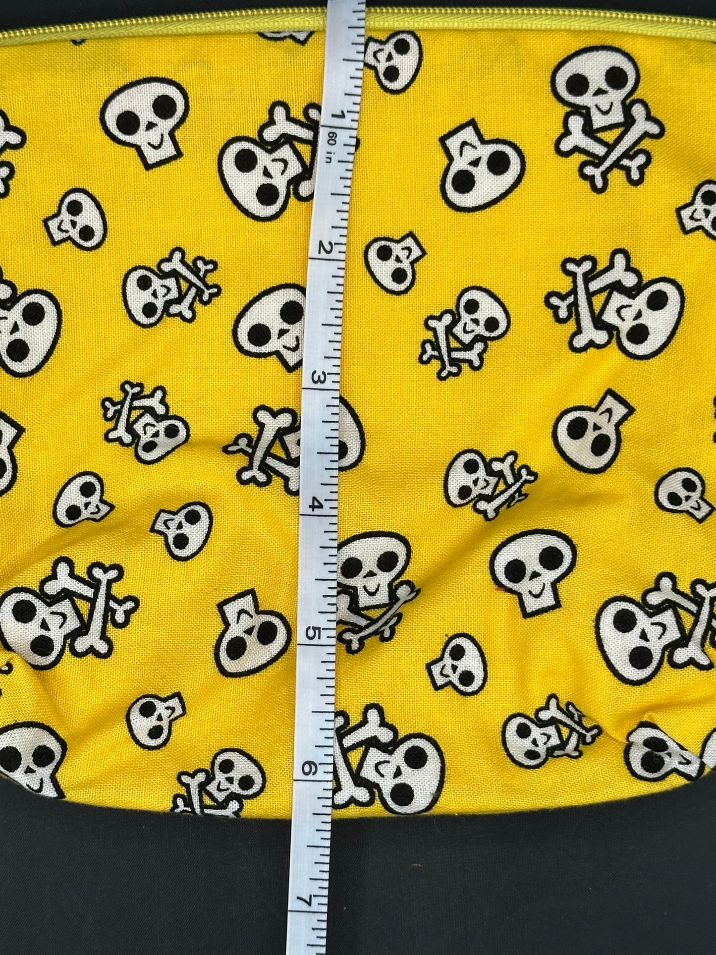 black skull and cross bones on yellow