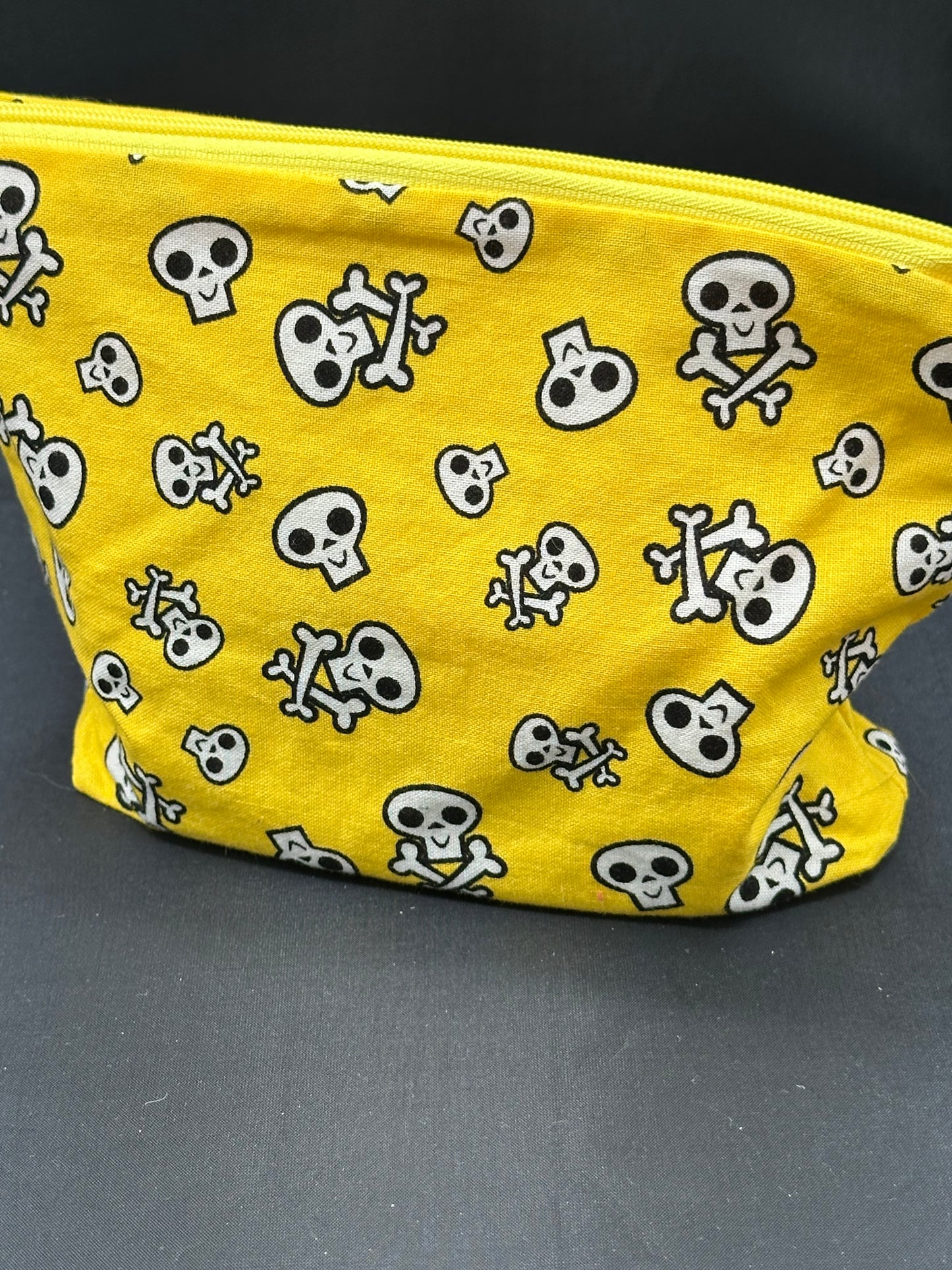 black skull and cross bones on yellow