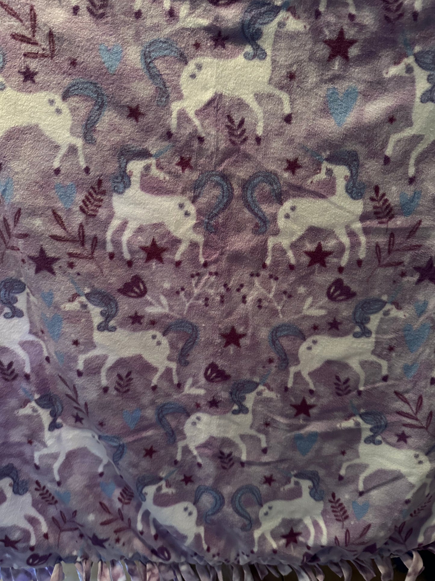 unicorns on purple fleece blanket