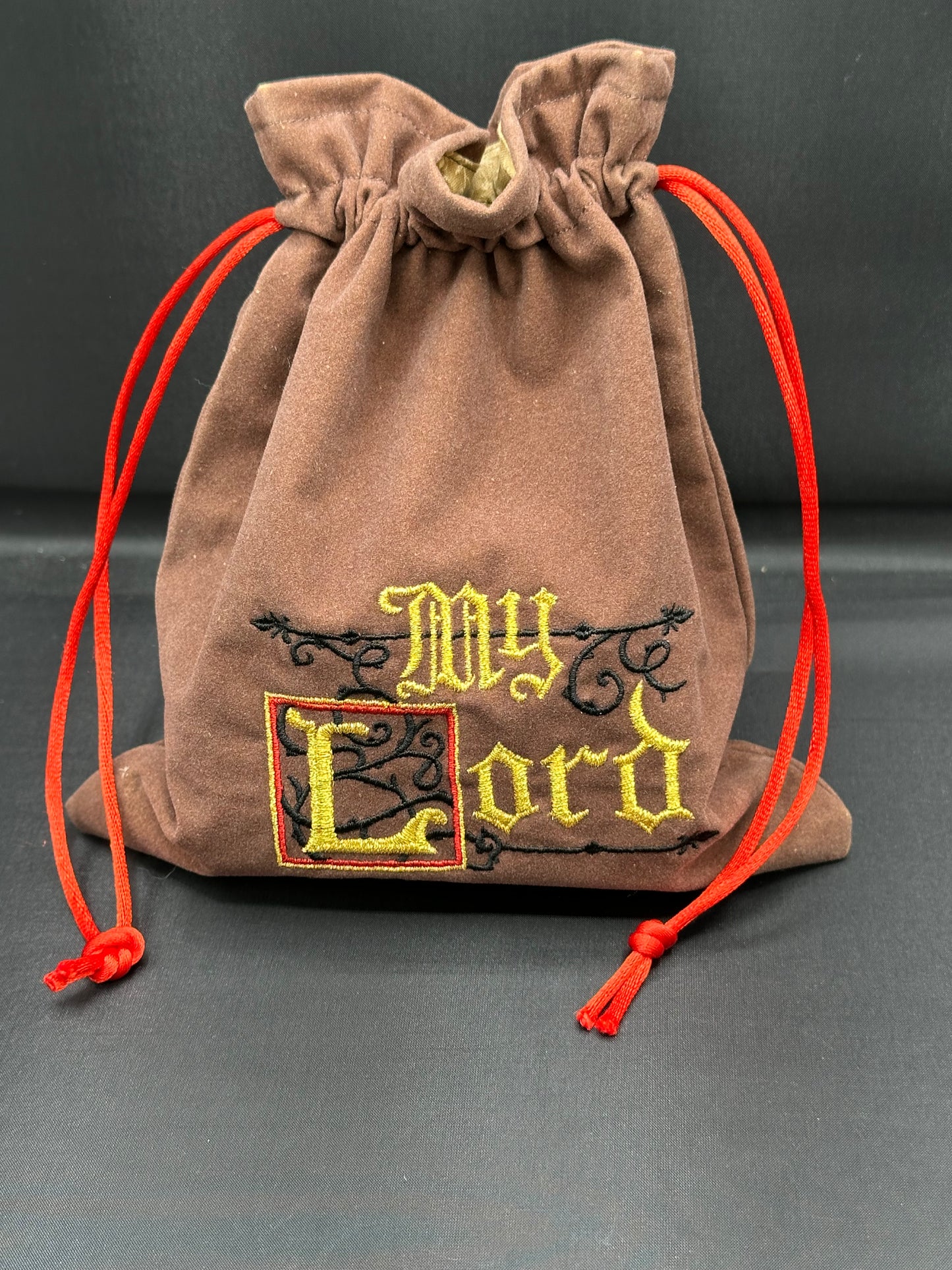 Embroidered My Lord on brown suede draw string bag