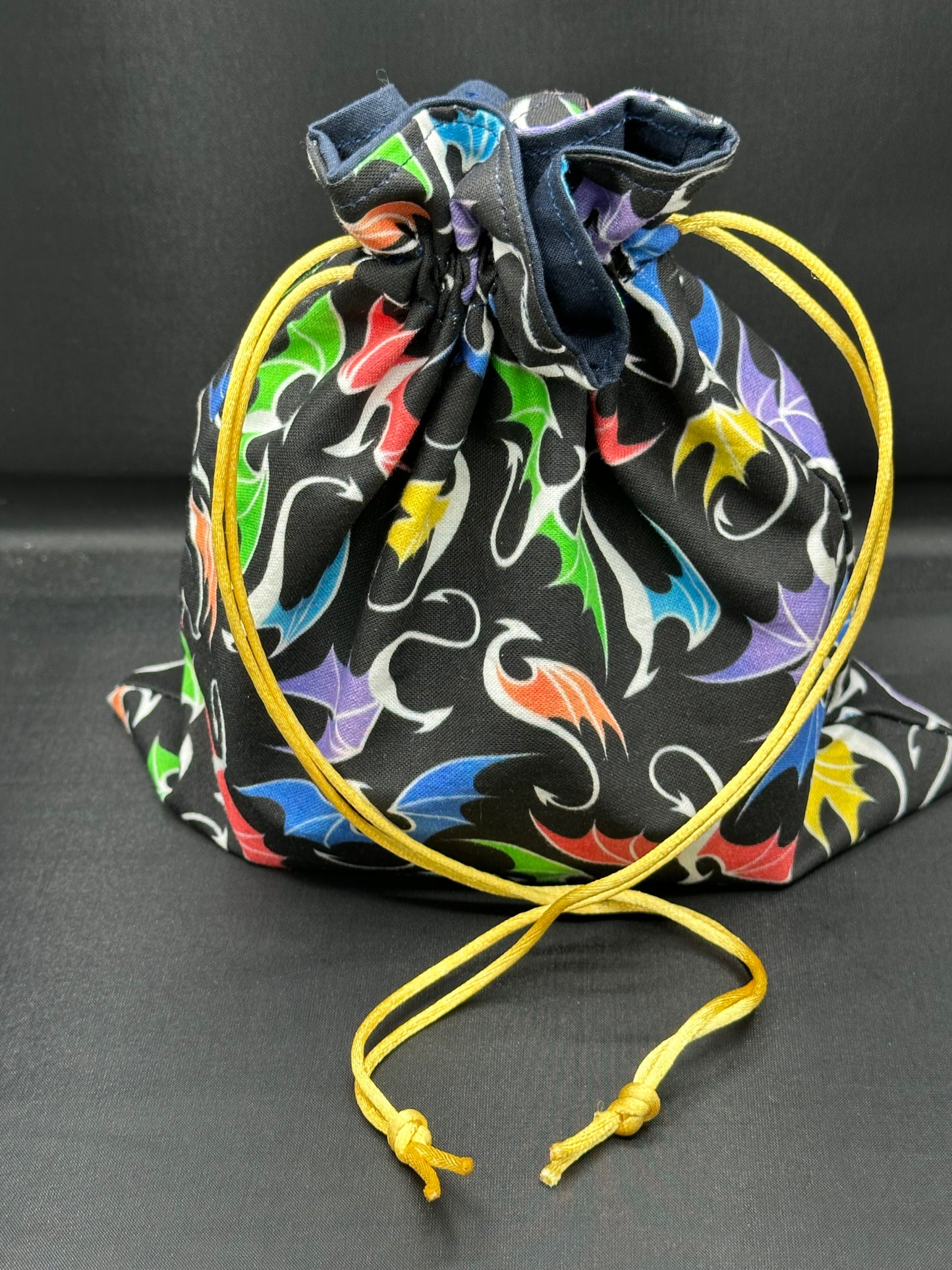 multi colored dragons on black draw string bag