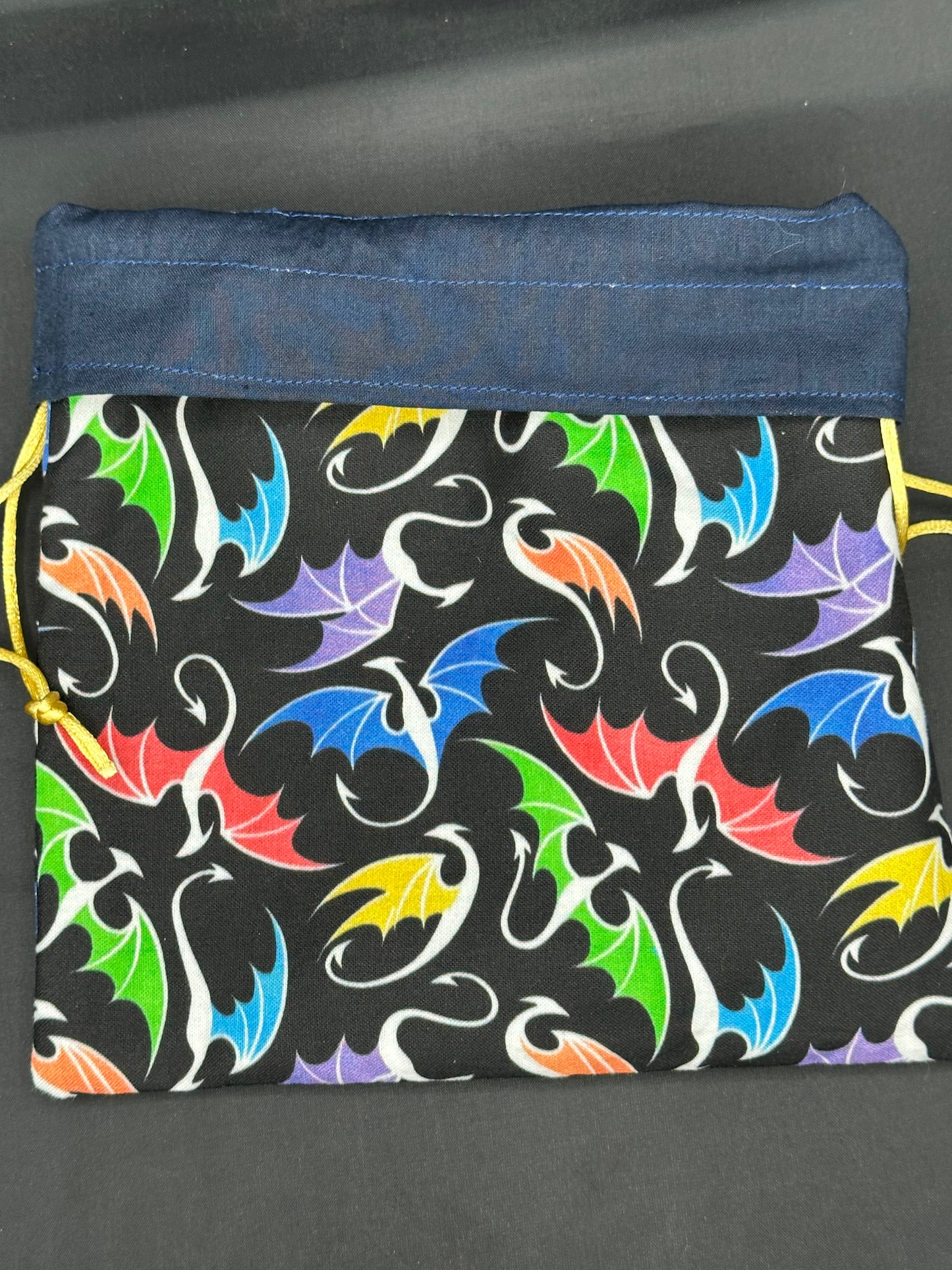 multi colored dragons on black draw string bag