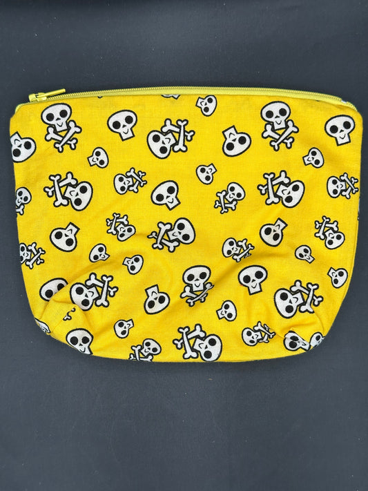 black skull and cross bones on yellow