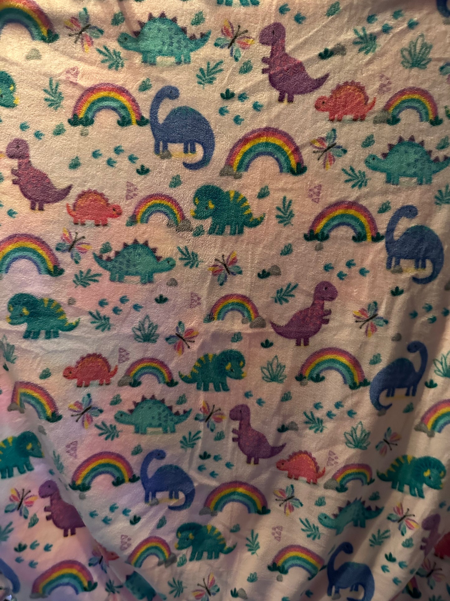 dinosaurs on pink background fleece blanket
