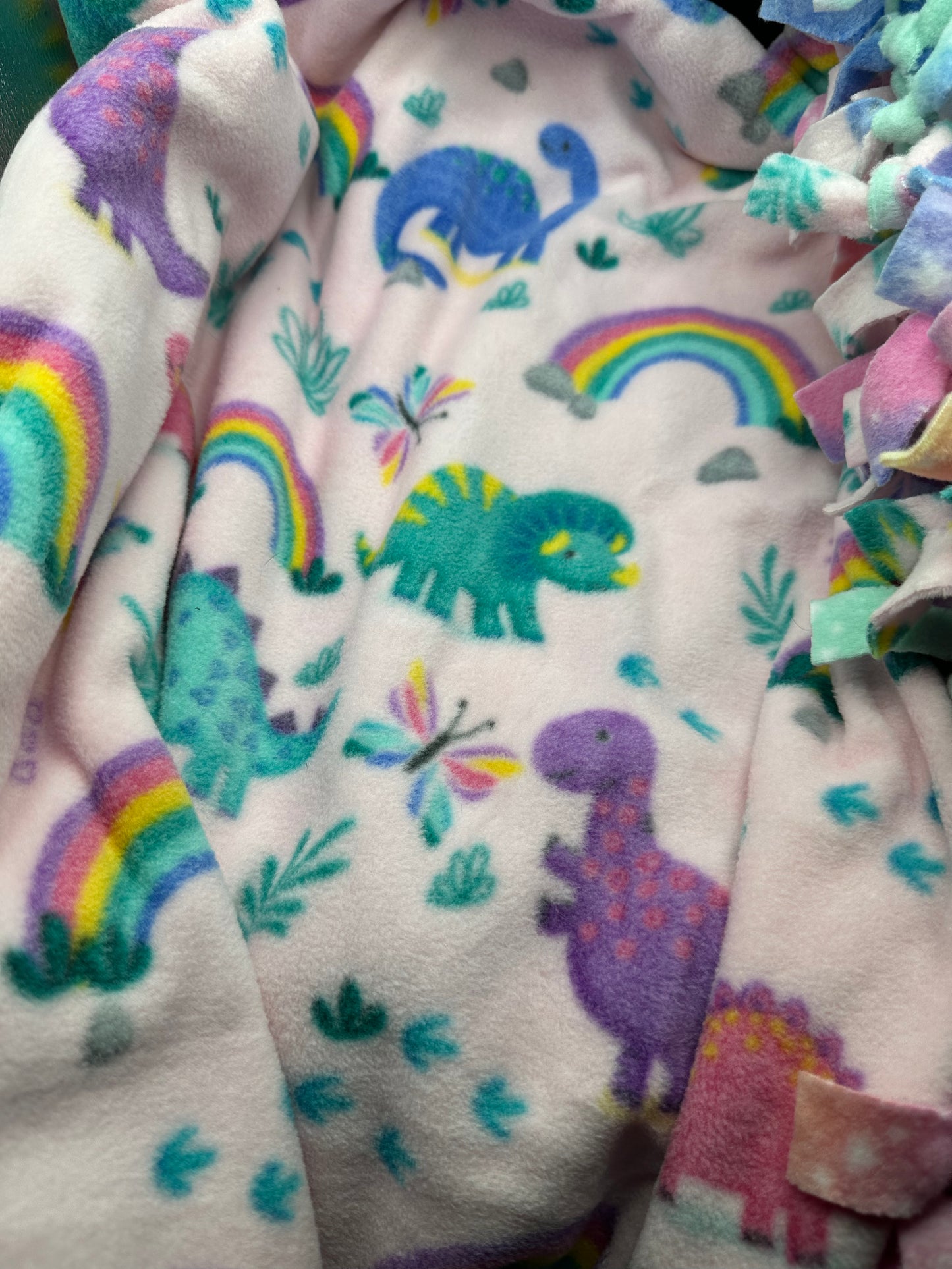 dinosaurs on pink background fleece blanket