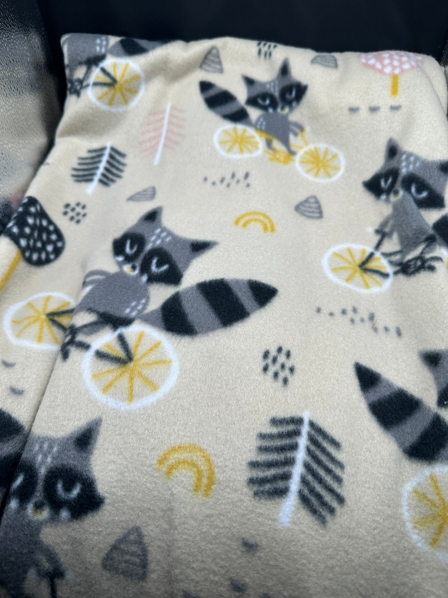 raccoons on bikes fleece blanket