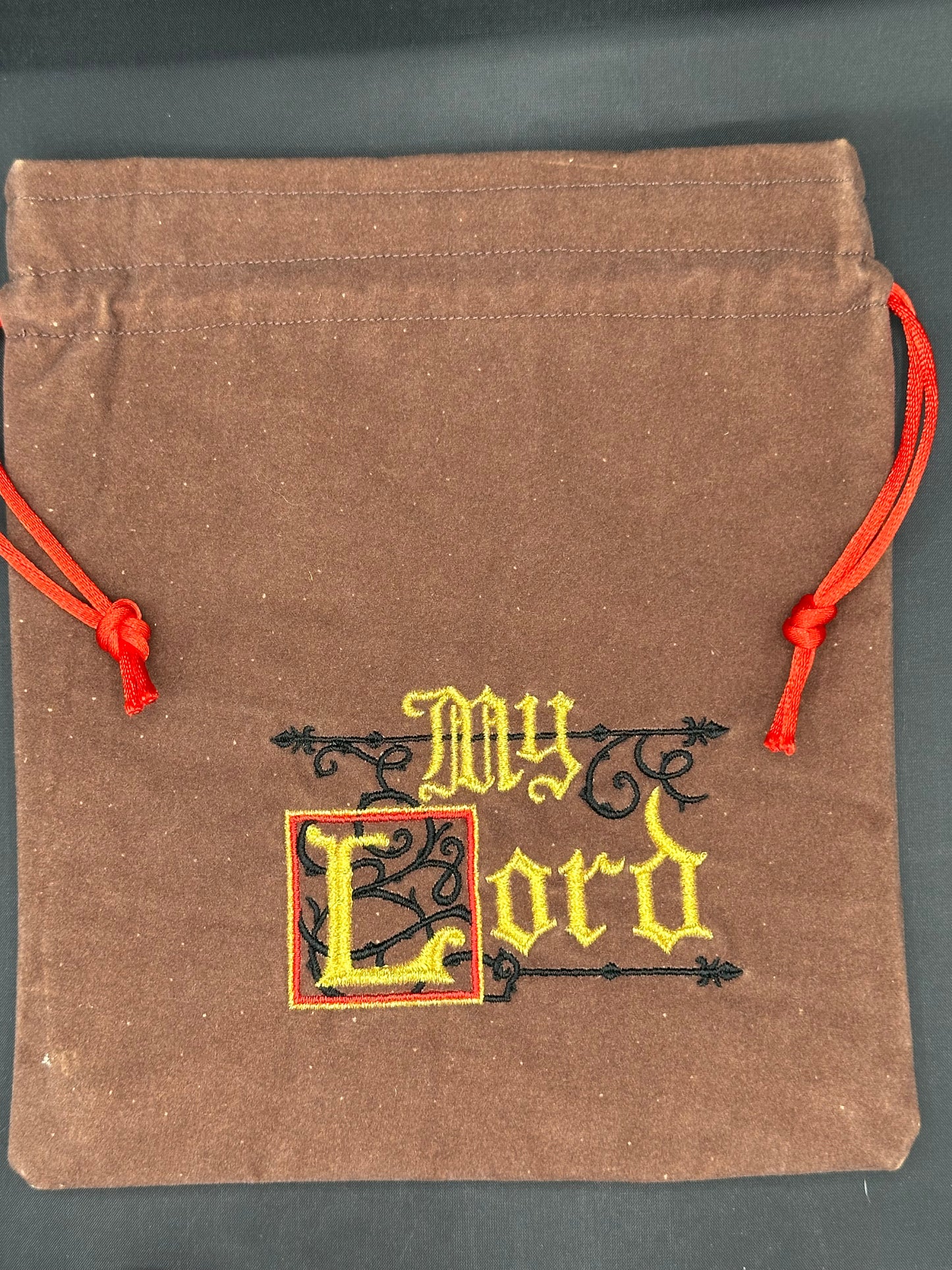 Embroidered My Lord on brown suede draw string bag