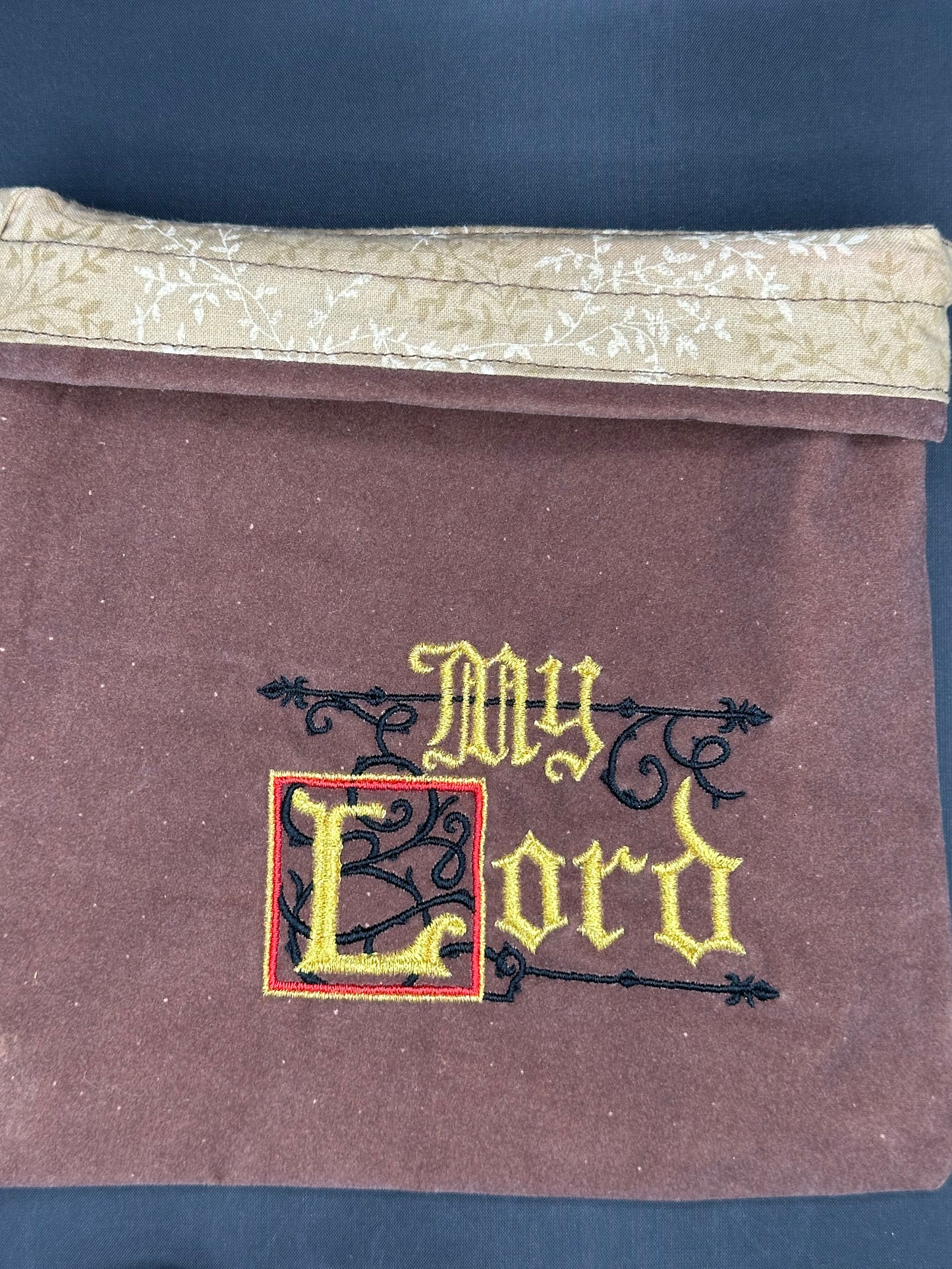 Embroidered My Lord on brown suede draw string bag